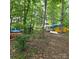 Outdoor canoe and kayak storage area surrounded by trees at 6795 Montgomery Rd, Lake Wylie, SC 29710