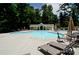Large community pool with lots of lounge chairs and tables with umbrellas, and pool house at 6795 Montgomery Rd, Lake Wylie, SC 29710