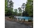 Community pool surrounded by mature trees, lounge chairs, and a black fence at 6795 Montgomery Rd, Lake Wylie, SC 29710