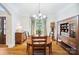 Formal dining area with elegant lighting, hardwood floors, and traditional decor at 6795 Montgomery Rd, Lake Wylie, SC 29710