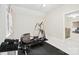 Bright exercise room featuring weights and an elliptical machine next to an open doorway at 6795 Montgomery Rd, Lake Wylie, SC 29710