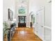 Bright foyer with hardwood floors, a high ceiling, and a large front door is a welcoming space at 6795 Montgomery Rd, Lake Wylie, SC 29710