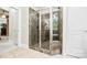 This bathroom features a tiled walk-in shower with glass doors and a built-in bench at 6795 Montgomery Rd, Lake Wylie, SC 29710