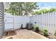 Private backyard area with white fence, patio space, and some green landscaping around the perimeter at 7123 Meeting St, Charlotte, NC 28210