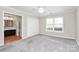Spacious bedroom with a ceiling fan, a bright window, and closet access to the bathroom at 7123 Meeting St, Charlotte, NC 28210