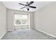 Neutral bedroom features a ceiling fan, carpet flooring, and a window at 7123 Meeting St, Charlotte, NC 28210