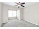 Neutral bedroom features carpet flooring, a ceiling fan, and a window at 7123 Meeting St, Charlotte, NC 28210