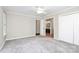 Large bedroom with a ceiling fan, bright windows, and access to bathroom and closet at 7123 Meeting St, Charlotte, NC 28210