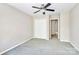 Bedroom features carpet flooring, a ceiling fan, and a double door closet at 7123 Meeting St, Charlotte, NC 28210