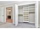 Bedroom closet featuring built-in shelving, storage space, and accessibility to the bathroom at 7123 Meeting St, Charlotte, NC 28210