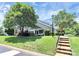 Well-kept lawn and landscaping around a townhouse, featuring steps leading to the entrance at 7123 Meeting St, Charlotte, NC 28210