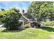 Landscaped front yard features mature trees, lush green grass, and well-maintained landscaping at 7123 Meeting St, Charlotte, NC 28210