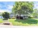 Charming home featuring a well-manicured lawn, mature tree, and appealing curb appeal in a tranquil setting at 7123 Meeting St, Charlotte, NC 28210