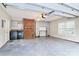 Spacious garage with finished walls, brick accent, overhead storage, and laundry area at 7123 Meeting St, Charlotte, NC 28210