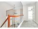 Hallway on the second level features a wooden railing and carpet flooring at 7123 Meeting St, Charlotte, NC 28210