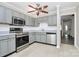 Cozy kitchen features gray cabinets, stainless steel appliances, and light tile flooring for a clean, modern look at 7123 Meeting St, Charlotte, NC 28210