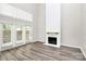 Bright living room with a painted fireplace, high ceilings, and large windows offering ample natural light at 7123 Meeting St, Charlotte, NC 28210
