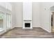 A bright living room boasts a painted fireplace as well as lots of natural light from the window and door at 7123 Meeting St, Charlotte, NC 28210