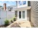 Enclosed patio with white fence, small garden area, and access to the home through glass doors at 7123 Meeting St, Charlotte, NC 28210