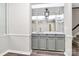 A mirrored wet bar with gray cabinets and countertop provides an elegant space for storage and refreshments at 7123 Meeting St, Charlotte, NC 28210