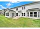Wide backyard featuring lush green lawn, the rear of the home with lots of windows, and a concrete patio at 7160 Sumters Camp Trl, Indian Land, SC 29707