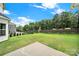 Wide backyard featuring lush green lawn, a partial view of the pool, and a dark stained wooden fence at 7160 Sumters Camp Trl, Indian Land, SC 29707