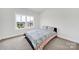 Comfortable bedroom with a bright window offers natural light, comfortable rest, and peaceful slumber at 7160 Sumters Camp Trl, Indian Land, SC 29707