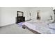 A well-lit bedroom features a bed with a patterned quilt and a dark wood dresser with a mirror at 7160 Sumters Camp Trl, Indian Land, SC 29707