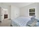 Cozy bedroom featuring floral bedding, a window, and double doors, providing comfort and convenience at 7160 Sumters Camp Trl, Indian Land, SC 29707