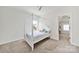 Bright bedroom with white four poster bed and view of exterior landscape through window at 7160 Sumters Camp Trl, Indian Land, SC 29707