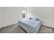 Inviting bedroom featuring a bed with floral bedding and a window, offering comfort and style at 7160 Sumters Camp Trl, Indian Land, SC 29707