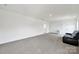 Large bonus room featuring neutral carpet, plenty of open space, and comfortable black leather seating at 7160 Sumters Camp Trl, Indian Land, SC 29707