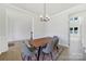 Stylish dining room with modern light fixture, wainscoting, hardwood floors, and modern furniture at 7160 Sumters Camp Trl, Indian Land, SC 29707