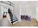 Inviting entryway with staircase and view of dining room featuring modern table and chairs at 7160 Sumters Camp Trl, Indian Land, SC 29707