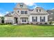 Charming two-story home with a stone archway, landscaped yard, and lovely curb appeal at 7160 Sumters Camp Trl, Indian Land, SC 29707