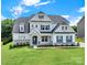 Attractive two-story home featuring a stone facade, dormer windows, and manicured lawn at 7160 Sumters Camp Trl, Indian Land, SC 29707