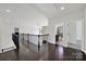 Open hallway leads to bedrooms and bathrooms with dark wood floors and natural lighting at 7160 Sumters Camp Trl, Indian Land, SC 29707