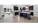 Contemporary kitchen features navy cabinets, stainless steel appliances, and an island with seating at 7160 Sumters Camp Trl, Indian Land, SC 29707
