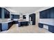 Modern kitchen with navy cabinets, quartz countertops, stainless steel appliances, and center island at 7160 Sumters Camp Trl, Indian Land, SC 29707