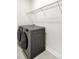 This laundry room features new gray washer and dryer with storage shelves at 7160 Sumters Camp Trl, Indian Land, SC 29707