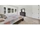 The main bedroom features a dark wood dresser, plush carpet and a bay window at 7160 Sumters Camp Trl, Indian Land, SC 29707
