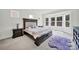 Bright main bedroom features a bay window, plush carpeting, and a decorative bed frame at 7160 Sumters Camp Trl, Indian Land, SC 29707