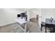 A bright home office featuring a white desk with computer setup and views of the hallway and piano at 7160 Sumters Camp Trl, Indian Land, SC 29707