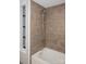 Bathroom featuring a bathtub with a tiled shower and open shelving unit at 728 Morningside Dr, Mount Holly, NC 28120