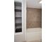 Bathroom featuring a bathtub with a tiled shower and open shelving unit at 728 Morningside Dr, Mount Holly, NC 28120