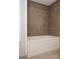 Bathroom featuring a bathtub with a tiled shower with beautiful tile surround at 728 Morningside Dr, Mount Holly, NC 28120