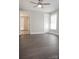 Spacious bedroom featuring dark wood floors, ceiling fan, and two windows for natural light at 728 Morningside Dr, Mount Holly, NC 28120