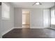 Spacious bedroom featuring dark wood floors, ceiling fan, and two windows for natural light at 728 Morningside Dr, Mount Holly, NC 28120