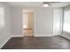 Spacious bedroom featuring dark wood floors, ceiling fan, and two windows for natural light at 728 Morningside Dr, Mount Holly, NC 28120