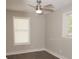 This is a bedroom featuring hardwood floors, a ceiling fan, and natural light from two windows at 728 Morningside Dr, Mount Holly, NC 28120